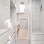 white walk in robes, through to ensuite with light floor boards