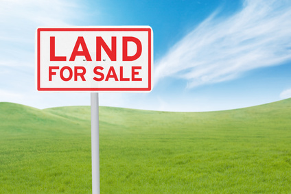 Land for sale sign on hill