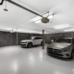 Large garage with white ceilings and floors with 2 prestige cars, built as a custom home