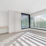 Neutral carpet, cream wall colour, black large window frames in luxury custom home