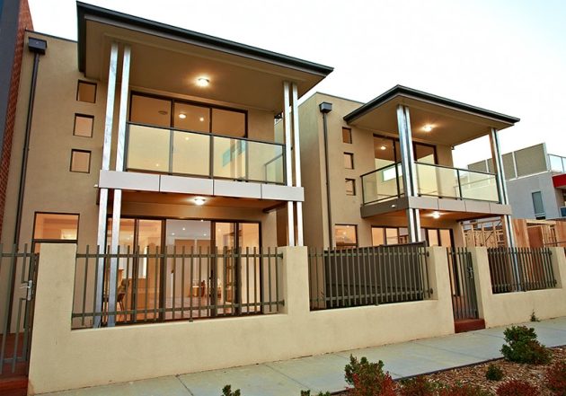 Double storey dual occupancy with glass front and cream rendered brickwork in Maribyrnong