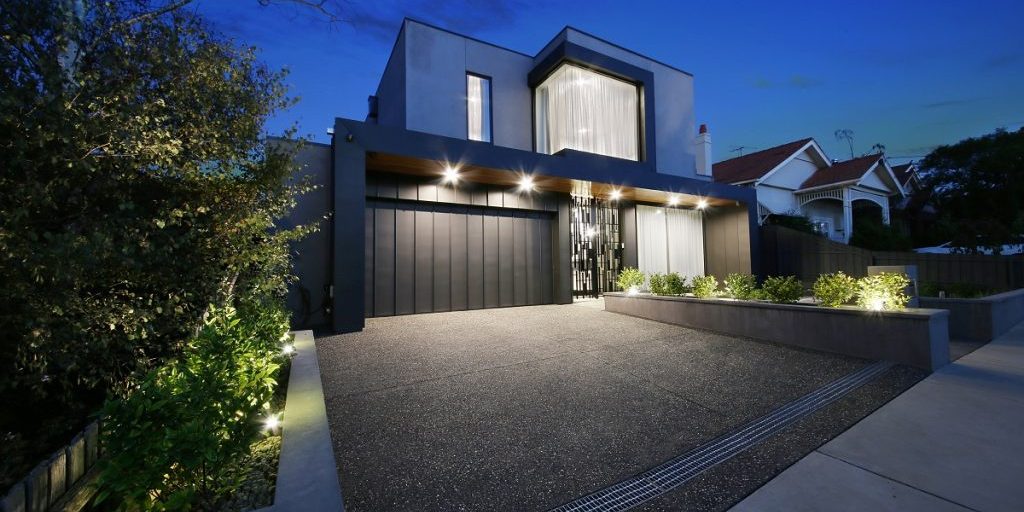 custom double storey home with charcoal facade, drive and garage