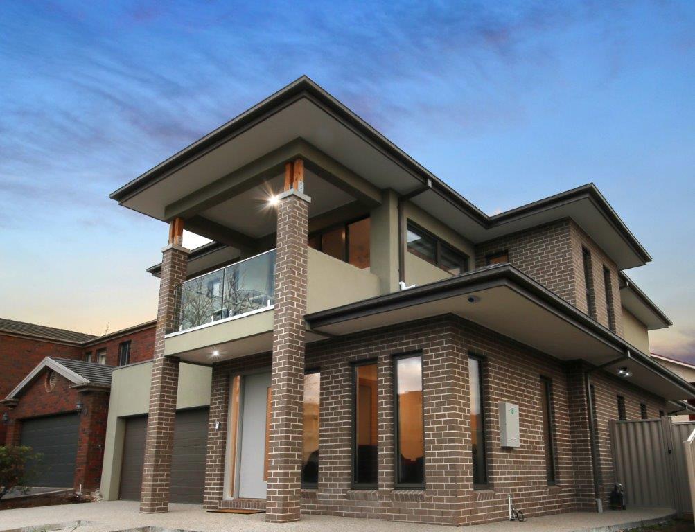 custom built double storey home. Front entrance with garage, brick and render style