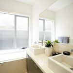 custom home bathroom design, window, bath, rectangular wash basins, cupboards and taps.